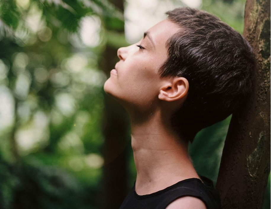 Woman leaning on a tree